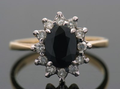 Lot 3 - An 18ct sapphire and diamond cluster ring, the...