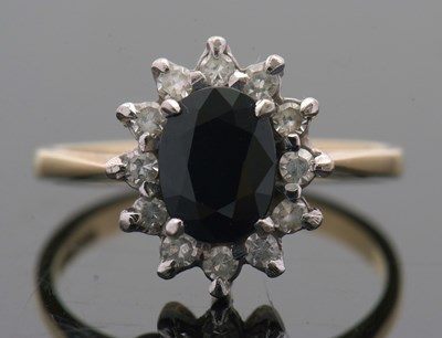 Lot 3 - An 18ct sapphire and diamond cluster ring, the...