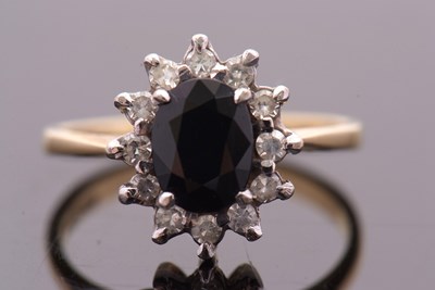 Lot 3 - An 18ct sapphire and diamond cluster ring, the...