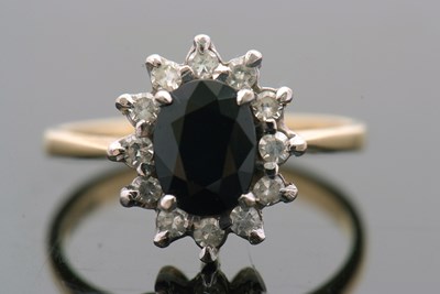 Lot 3 - An 18ct sapphire and diamond cluster ring, the...