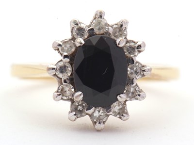 Lot 3 - An 18ct sapphire and diamond cluster ring, the...