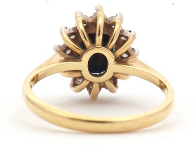 Lot 3 - An 18ct sapphire and diamond cluster ring, the...