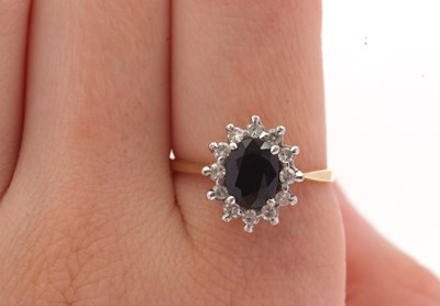 Lot 3 - An 18ct sapphire and diamond cluster ring, the...