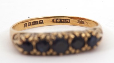 Lot 24 - A 9ct five stone sapphire ring, the slightly...