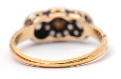 Lot 2 - A diamond cluster ring, with three small...