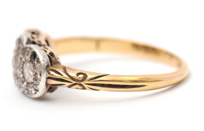 Lot 2 - A diamond cluster ring, with three small...