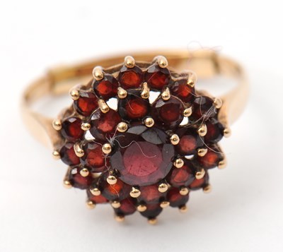 Lot 49 - A 9ct garnet cluster ring, with plain band...