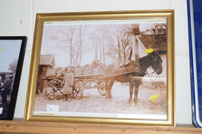 Lot 33 - A monochrome photograph of a coal merchant...