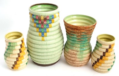 Lot 11 - A group of four Clarice Cliff raffia vases...