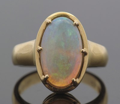 Lot 410 - An opal ring, the oval opal cabochon, approx....