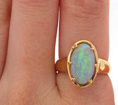 Lot 12 - An opal ring, the oval opal cabochon, approx....