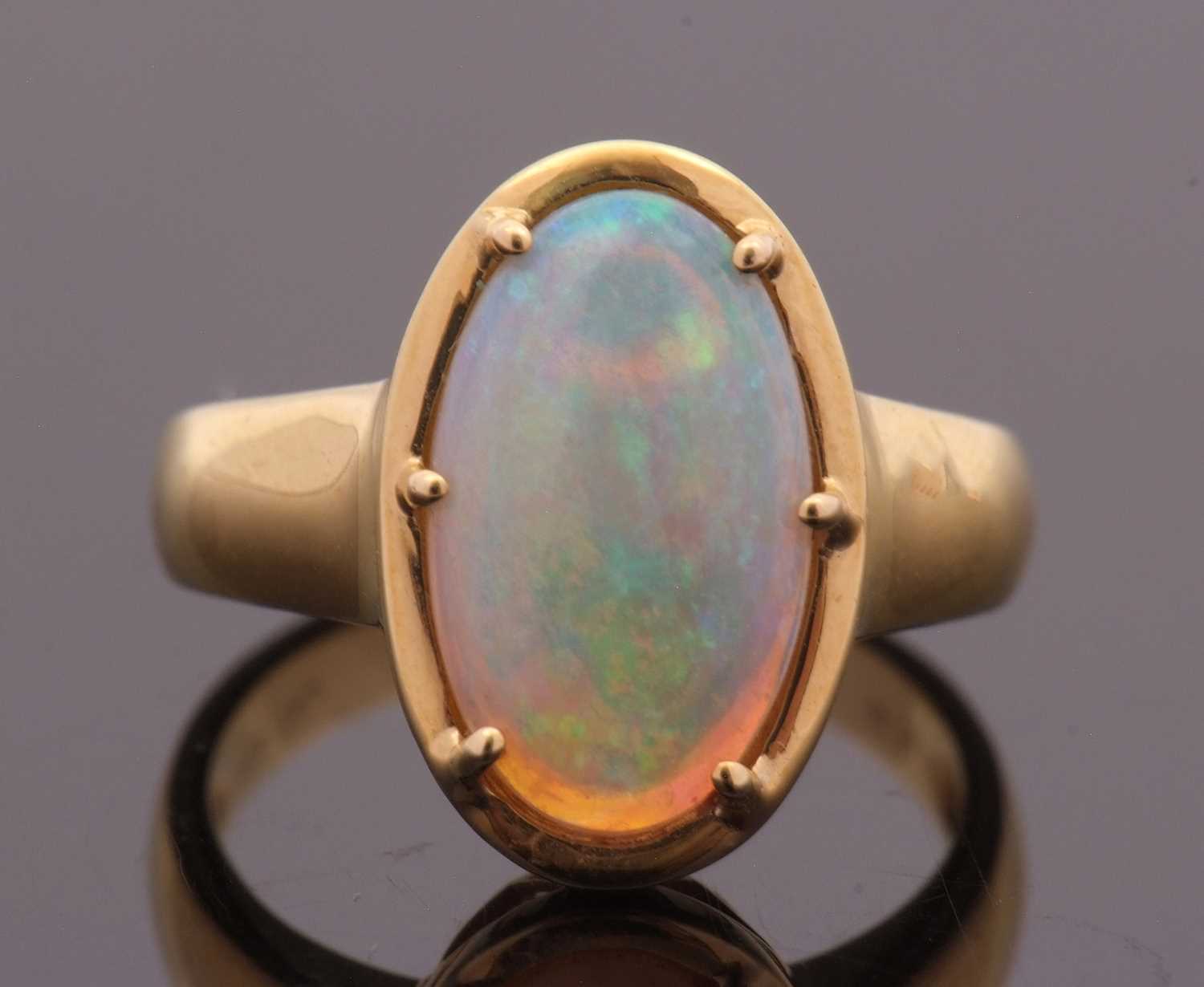 Lot 12 - An opal ring, the oval opal cabochon, approx....