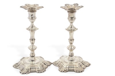 Lot 300 - A pair of George II cast silver candlesticks,...