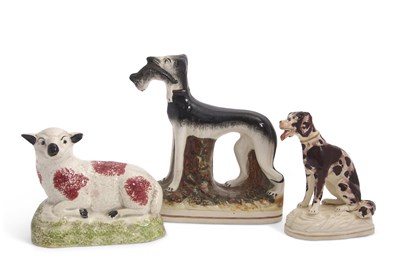 Lot 48 - A Staffordshire model of a greyhound with...