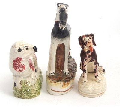Lot 48 - A Staffordshire model of a greyhound with...