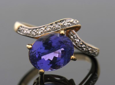 Lot 402 - An 18ct tanzanite and diamond ring, the oval...