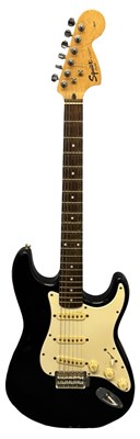 Lot 149 - A Fender Squier electric guitar in black with...