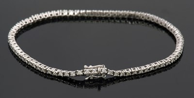 Lot 429 - A 9ct diamond line bracelet, set with round...
