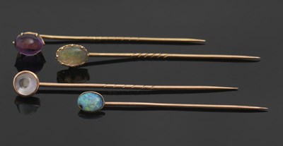 Lot 394 - Four gemset stick pins: to include an unmarked...