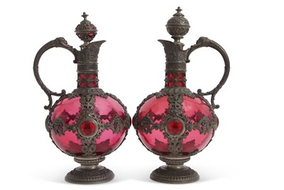 Lot 213 - A pair of continental cranberry glass ewers...