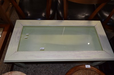Lot 287 - A glass top display coffee table
