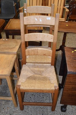Lot 321 - A pair of rush seat ladder back kitchen chairs