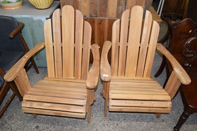 Lot 345 - A pair of modern hardwood recliner chairs
