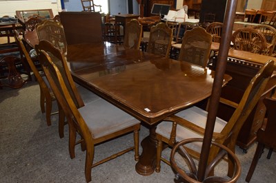 Lot 361 - An extending dining table and eight cane back...