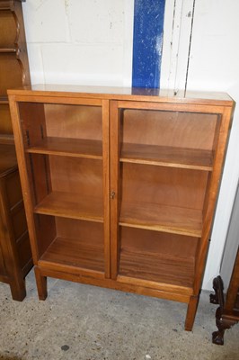 Lot 363 - A teak glazed two door bookcase