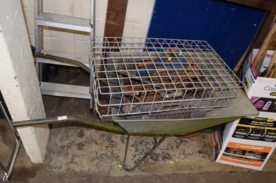 Lot 868 - A wheelbarrow containing a bench vice and...