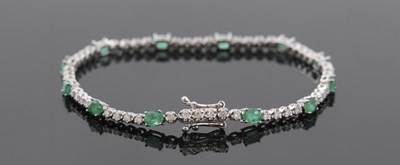 Lot 404A - An 18ct emerald and diamond bracelet, with...