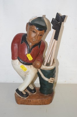 Lot 20 - A wooden model of a golfer with clubs