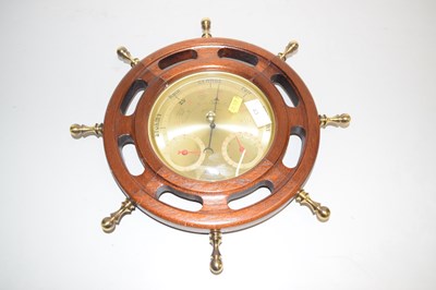 Lot 43 - A barometer in a ships wheel wooden frame
