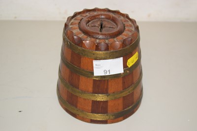 Lot 91 - A wooden barrel shaped money box