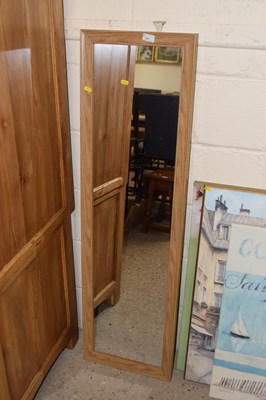 Lot 261 - A modern rectangular wall mirror in light wood...