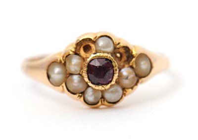 Lot 8 - A garnet and seed pearl ring, the central...