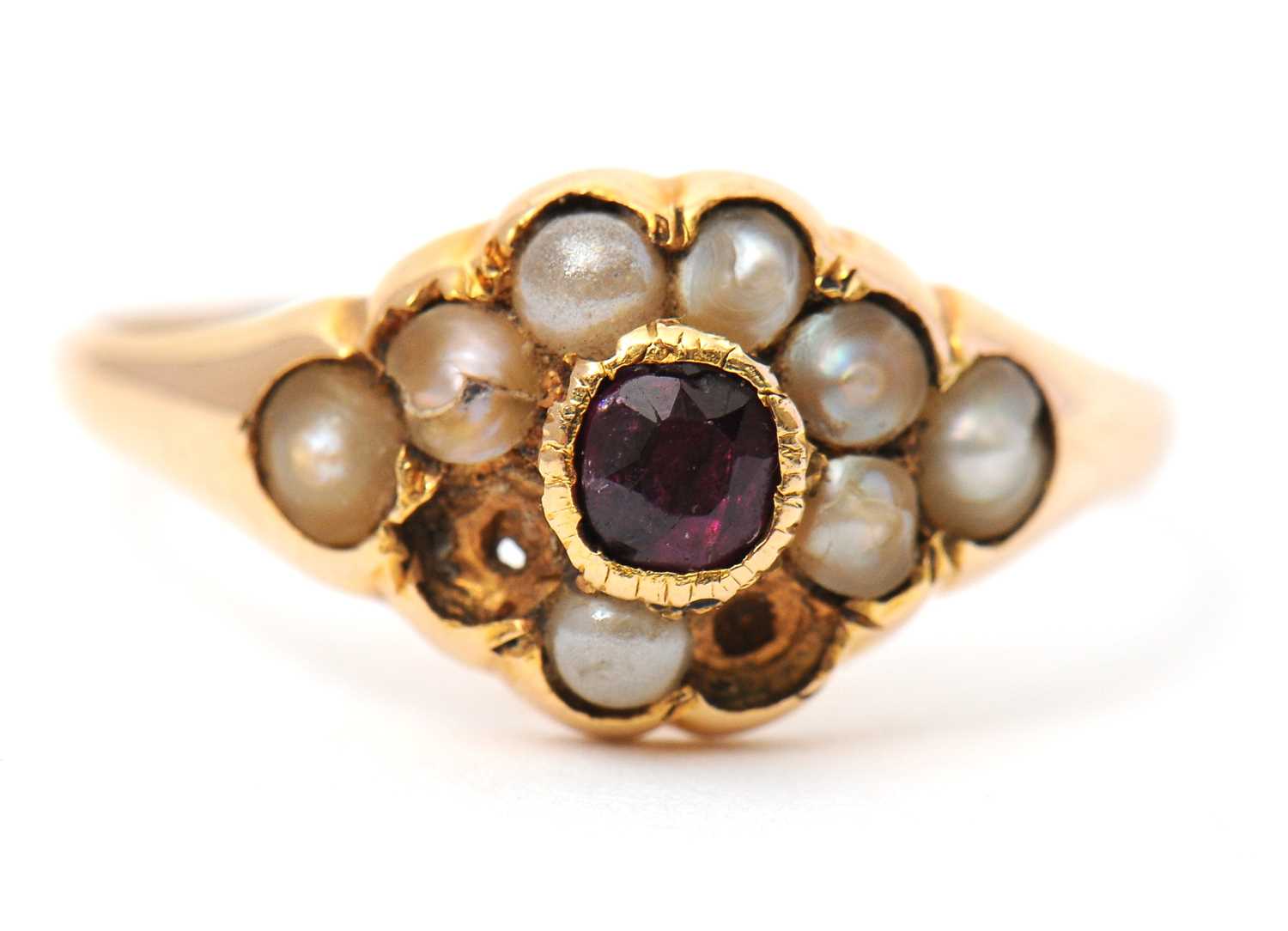 Lot 8 - A garnet and seed pearl ring, the central...