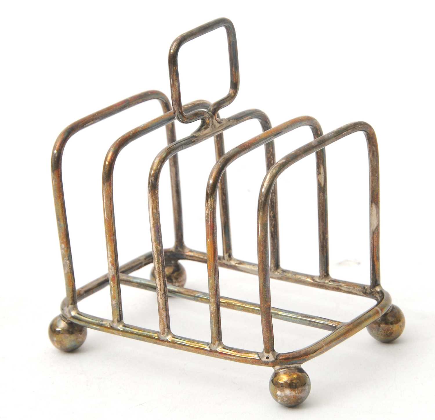 Lot 87 - An Edwardian silver toast rack featuring four...