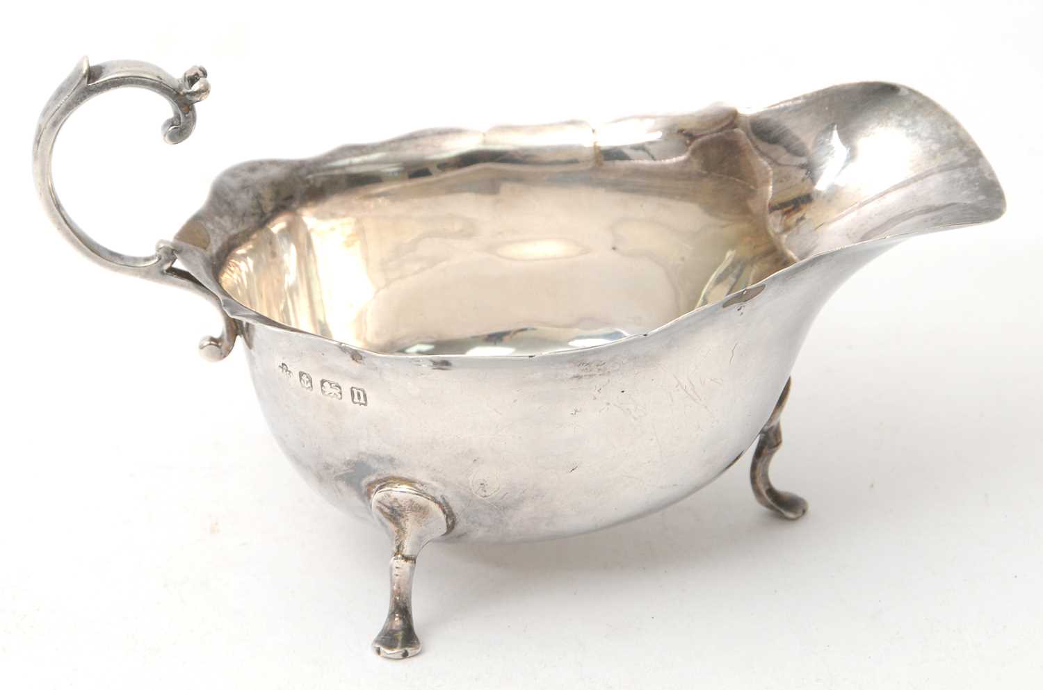 Lot 71 - A George V silver sauce boat of typical form...