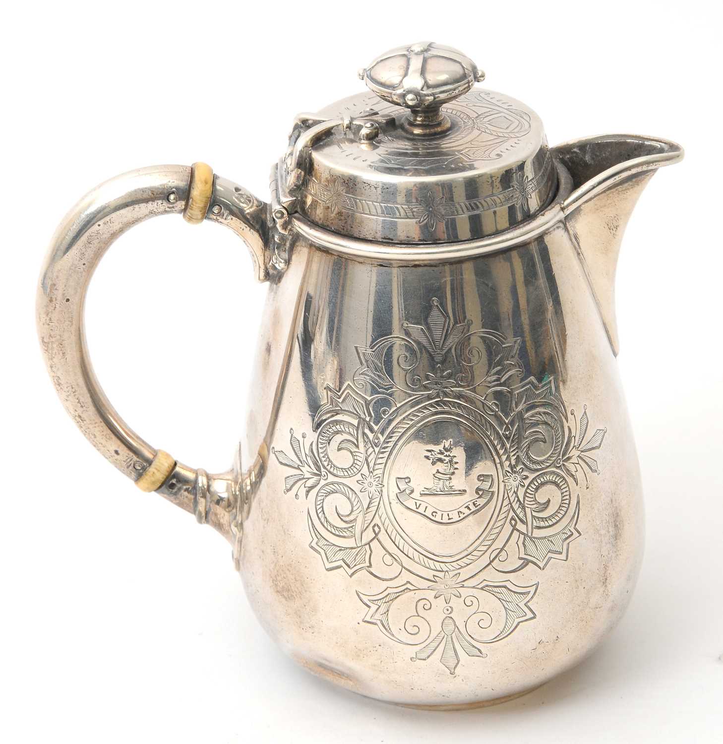 Lot 8 - A Victorian silver hot water jug of slight...