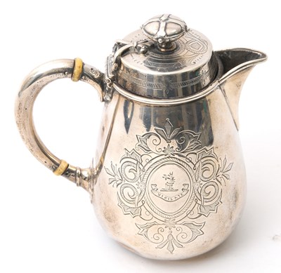 Lot 8 - A Victorian silver hot water jug of slight...