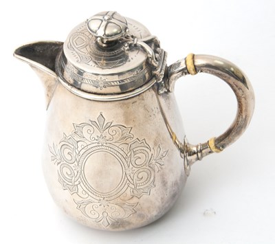 Lot 8 - A Victorian silver hot water jug of slight...