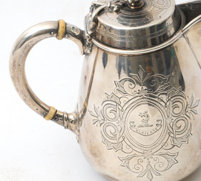 Lot 8 - A Victorian silver hot water jug of slight...