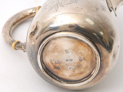 Lot 8 - A Victorian silver hot water jug of slight...
