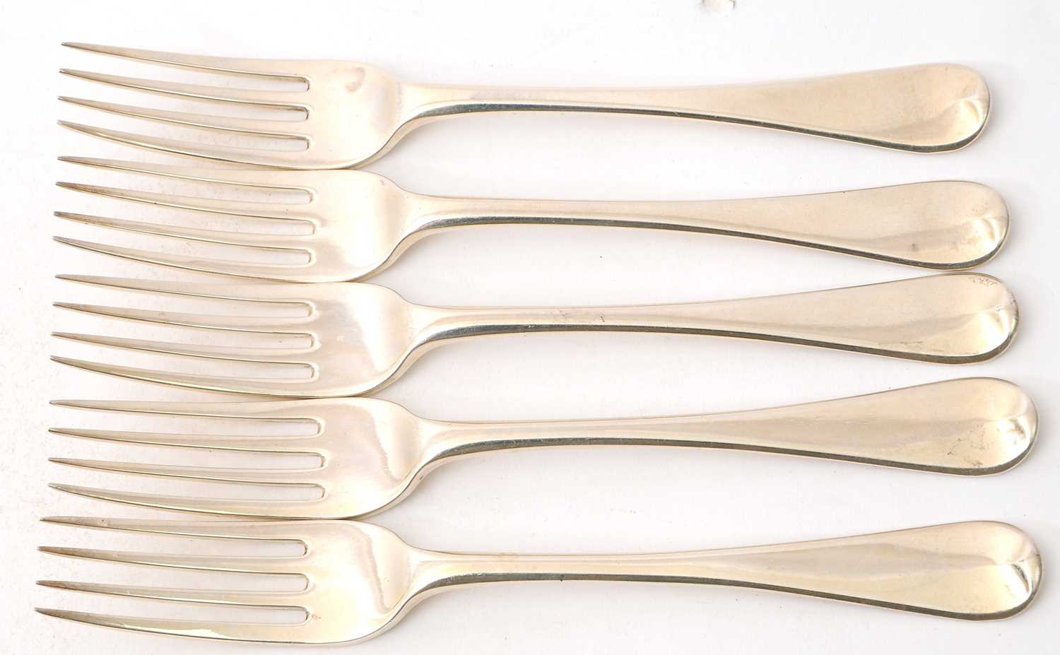 Lot 18 - A group of five George III silver table forks,...