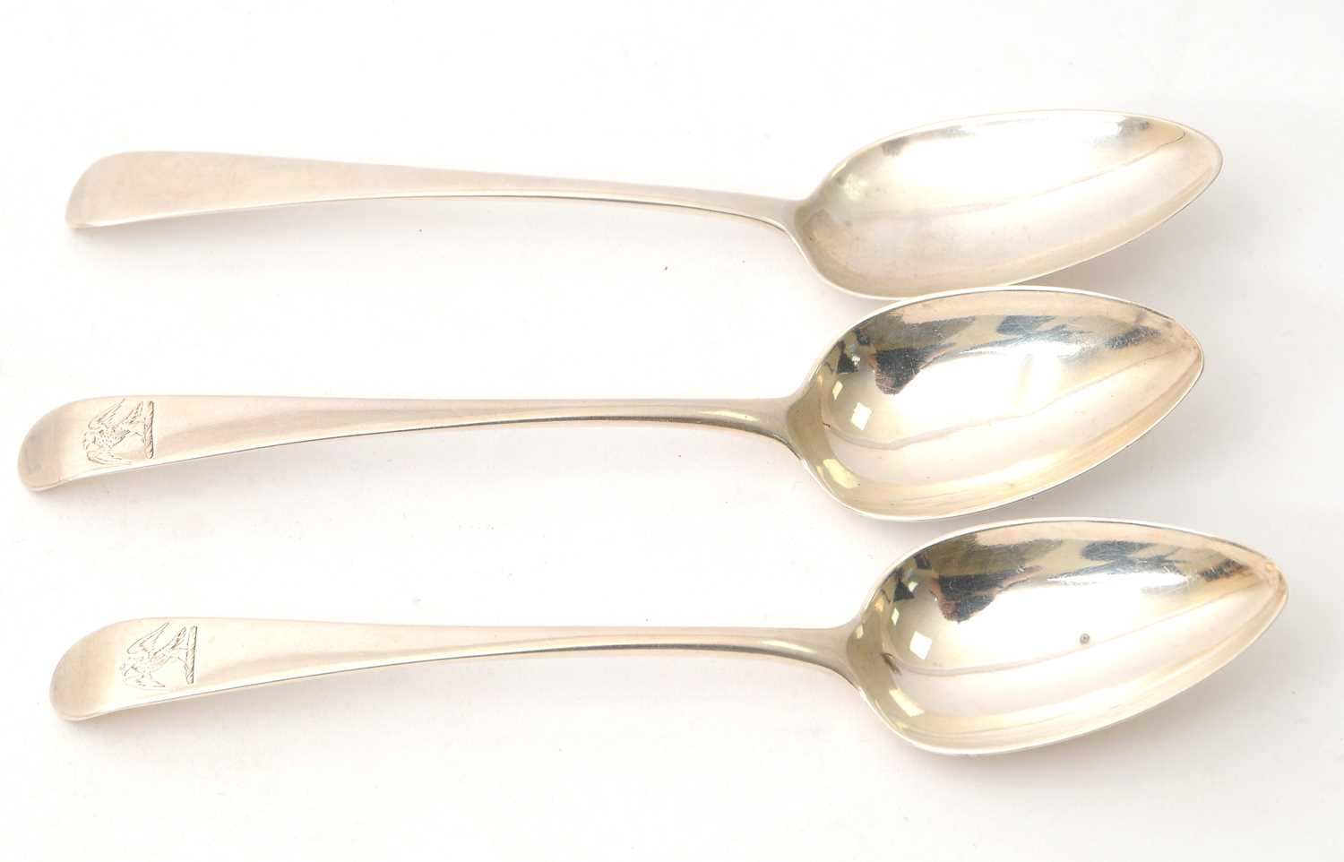 Lot 22 - Three George III silver dessert spoons with...
