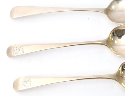 Lot 22 - Three George III silver dessert spoons with...