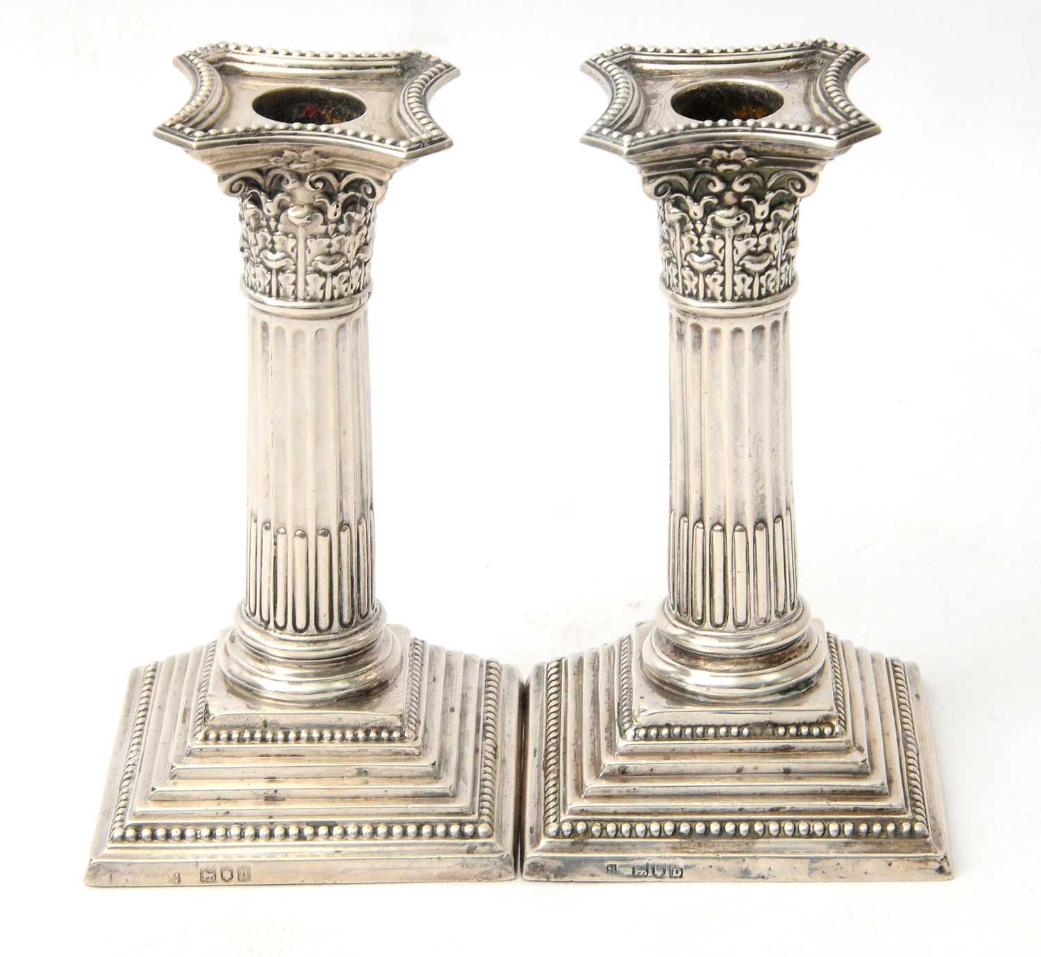 Lot 28 - A pair of late Victorian silver candlesticks...