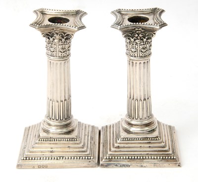 Lot 28 - A pair of late Victorian silver candlesticks...