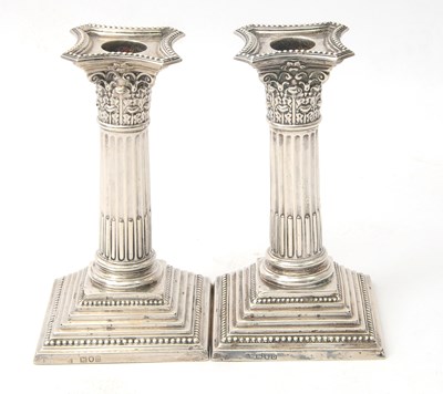 Lot 28 - A pair of late Victorian silver candlesticks...